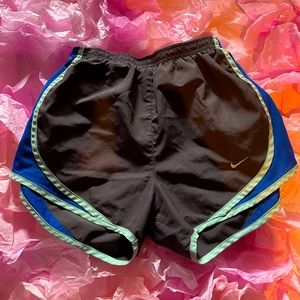 XS Dri-fit Nike grey shorts with dark blue and light blue details.